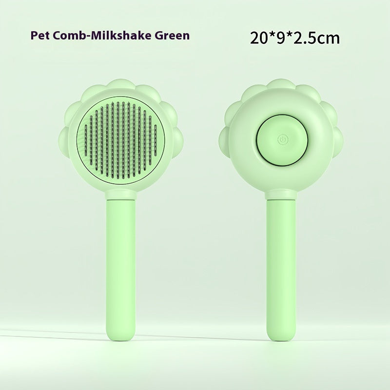 Green pet spray comb with round bristle brush head and button on flower handle