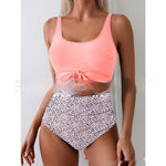 Pink one-piece swimsuit with tie-front waist and white dotted high-waist bottoms