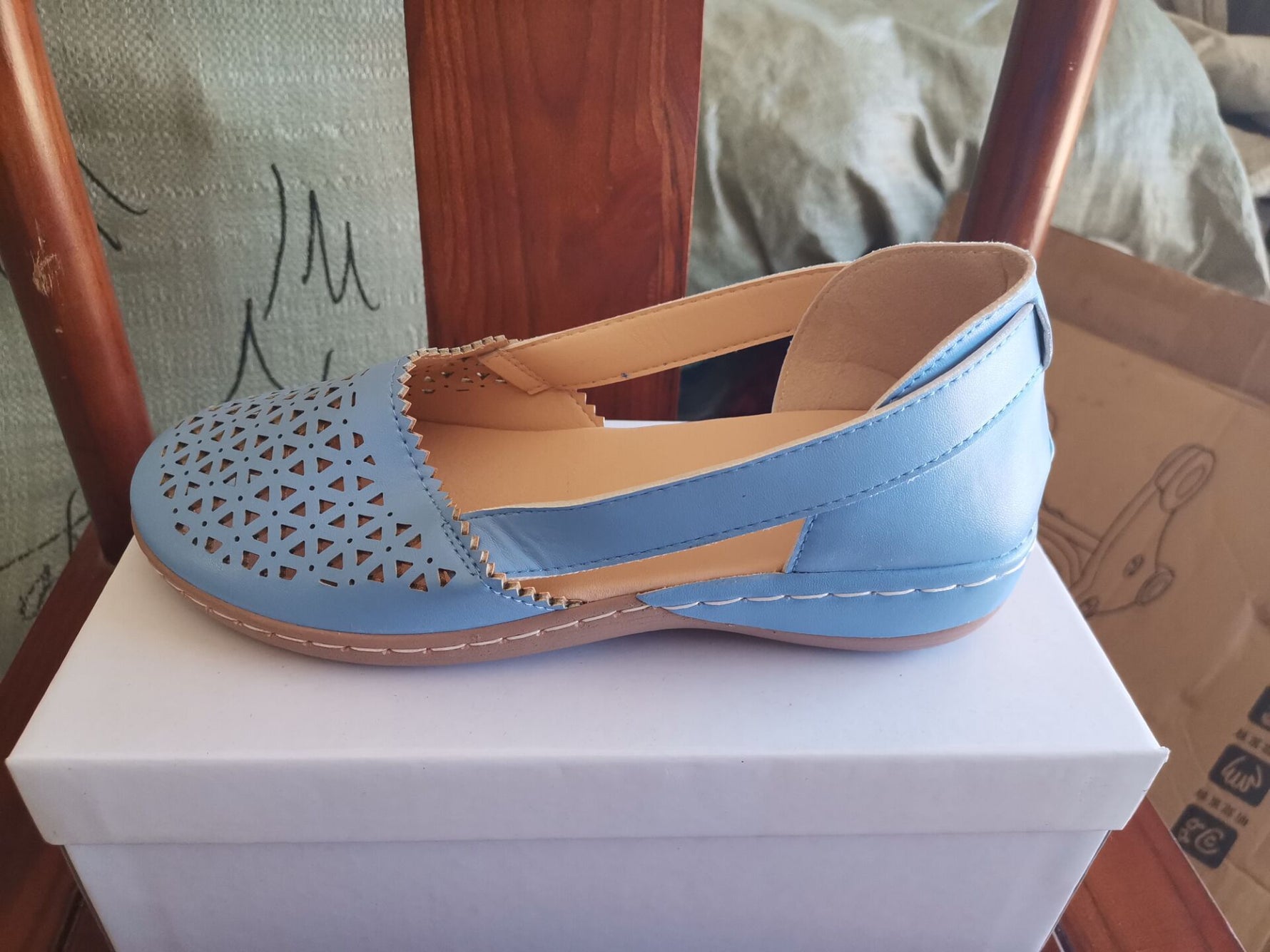 Light blue perforated women's wedge sandals with round toe and cross strap