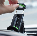Car phone holder release lever and cradle, hand pressing green button, black
