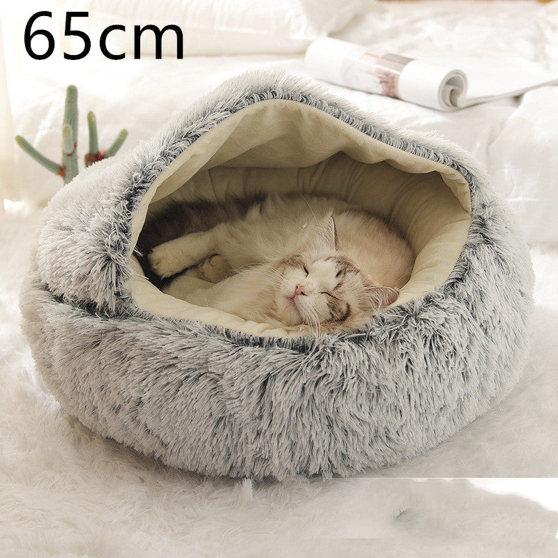 Grey round plush pet bed with cream inner cushion, cat sleeping inside.