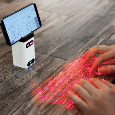 Portable laser projection keyboard with built-in mouse, showing red key pattern