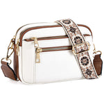 White crossbody bag with floral embroidered strap and gold hardware, side view