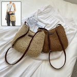 Woven straw shoulder tote with dark brown trim and zipper, with small matching pouch