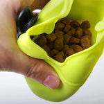 Yellow pet treat waist bag open, filled with brown training treats