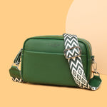 Genuine leather crossbody bag with green body and patterned wide strap with silver buckle