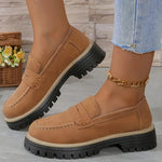 Beige round-toe flat loafers with buckle strap and black lug sole