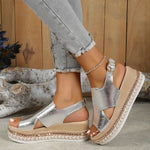 Silver shiny wedge sandals with crisscross straps and square buckle, woven platform