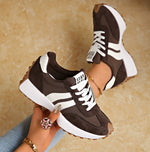 Casual sneakers in dark brown with white side stripes and white sole