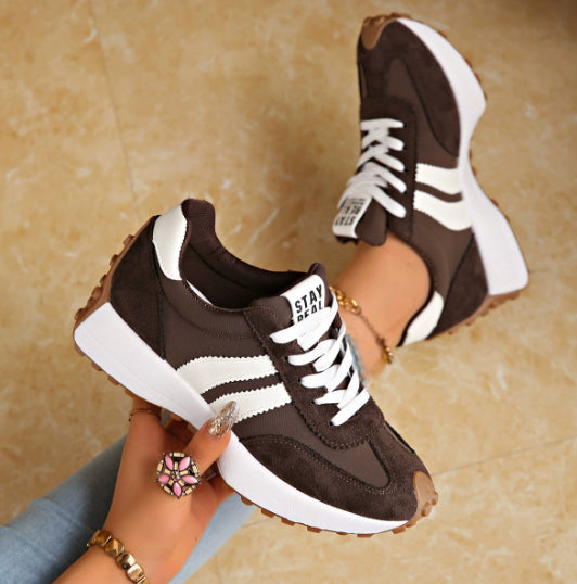Casual sneakers in dark brown with white side stripes and white sole