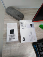 Laser projection keyboard retail boxes and accessories on a desk