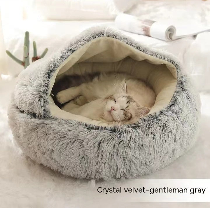 Round plush pet bed in gray plush, sleeping cat inside the cozy nest
