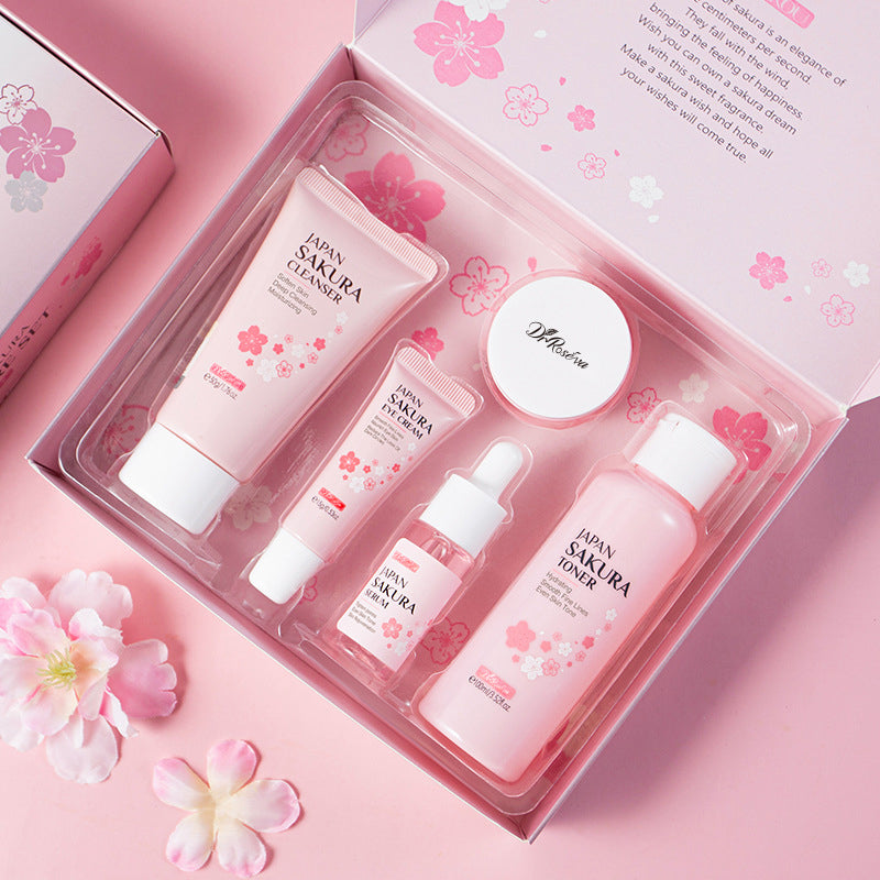 Skincare set tray with five pink Japan Sakura bottles and creams inside a pink box
