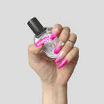 Press-on acrylic nails held with clear polish bottle; bright pink glitter and rhinestones