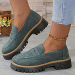 Dark green round-toe flat loafers with buckle strap and black lug sole