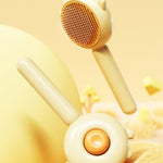 Yellow pet grooming brush with brown pin head and round orange control button