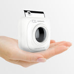 White mini thermal photo printer held in a hand, front lens window open