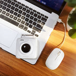 White mini thermal photo printer connected to a laptop with a cable