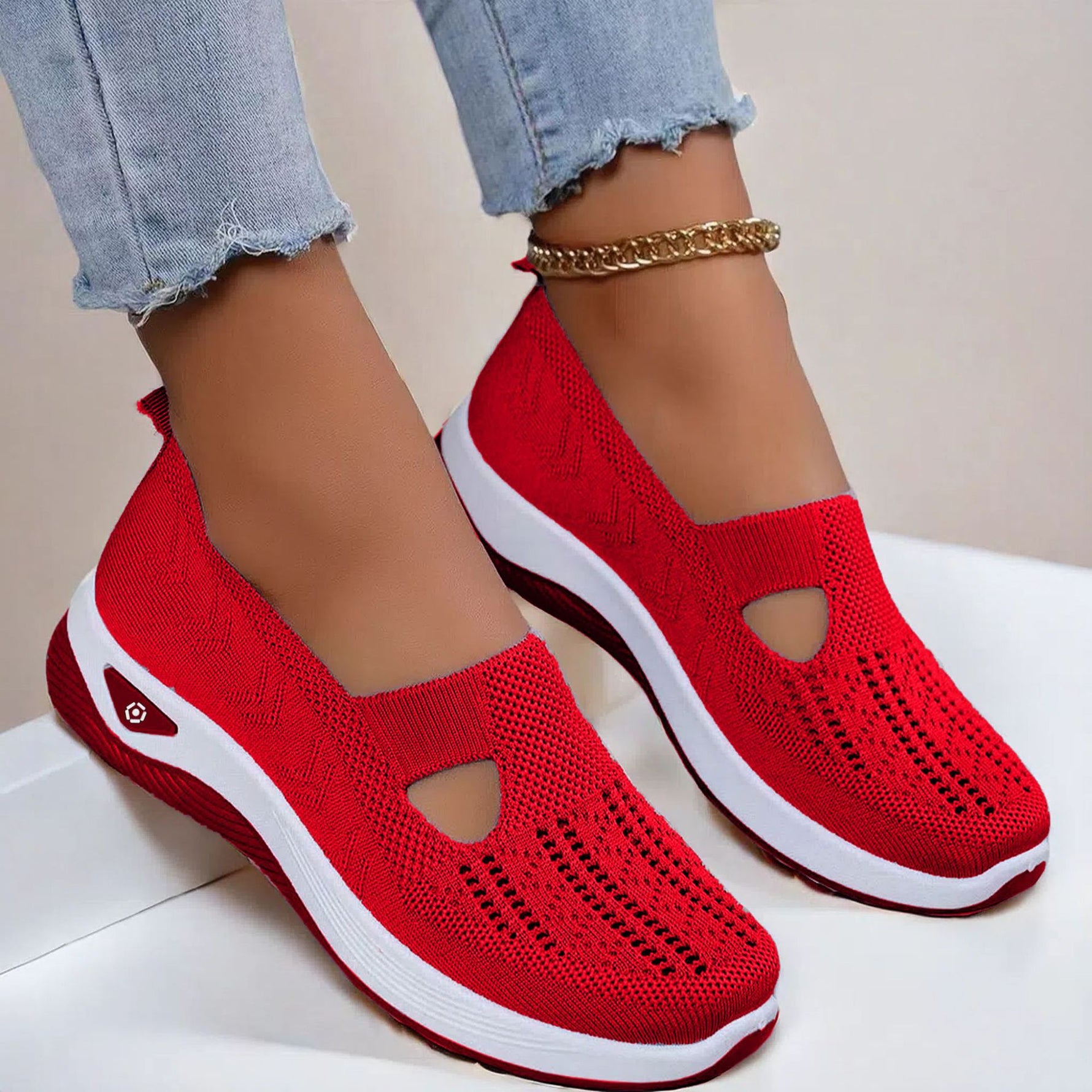 Women's mesh slip-on flats in red, cutout toe and white sole.
