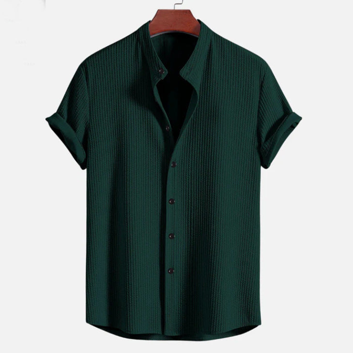 Dark green short sleeve button-up shirt with open collar and vertical textured finish