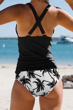 Women’s black halter bikini swimsuit with crisscross back and tropical-print bottoms