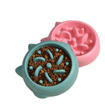 Pink slow feeder pet bowl with raised ridges and bumps, filled with kibble