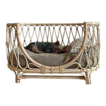 Handmade rattan pet bed with gray cushion and green-check pet blanket, front view