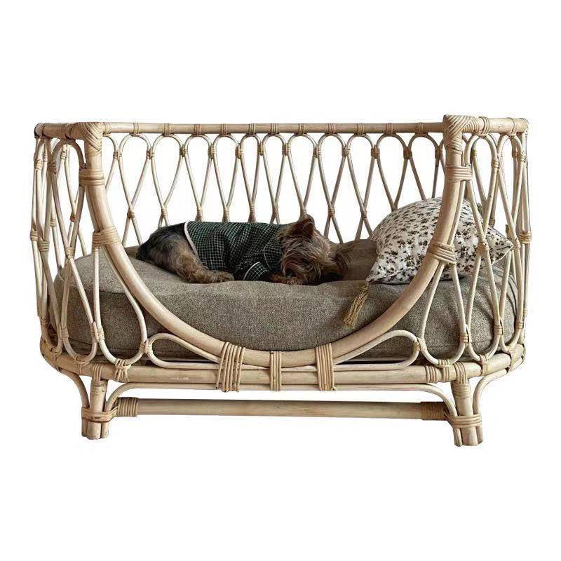Handmade rattan pet bed with gray cushion and green-check pet blanket, front view