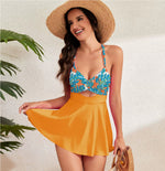 Cutout sling one-piece swimsuit: blue floral top, orange flared skirt, waist cutout