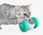 Teal-green interactive slow feed pet toy with rotating treat-dispensing wheel