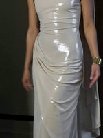 White one-shoulder bodycon maxi dress close-up with ruched pleats and draped panel