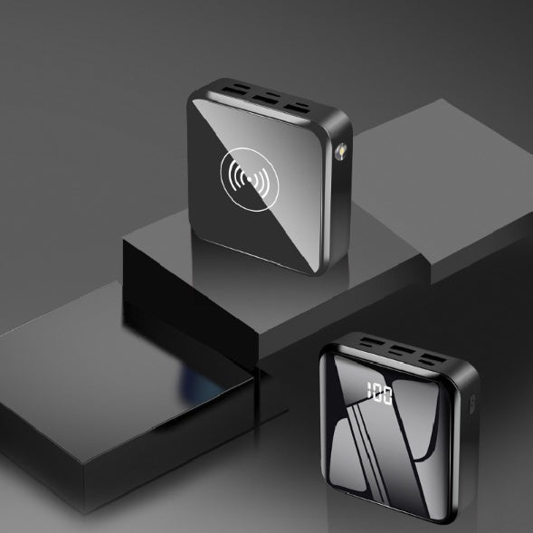 Black mini power bank with wireless charging icon and top vent ports