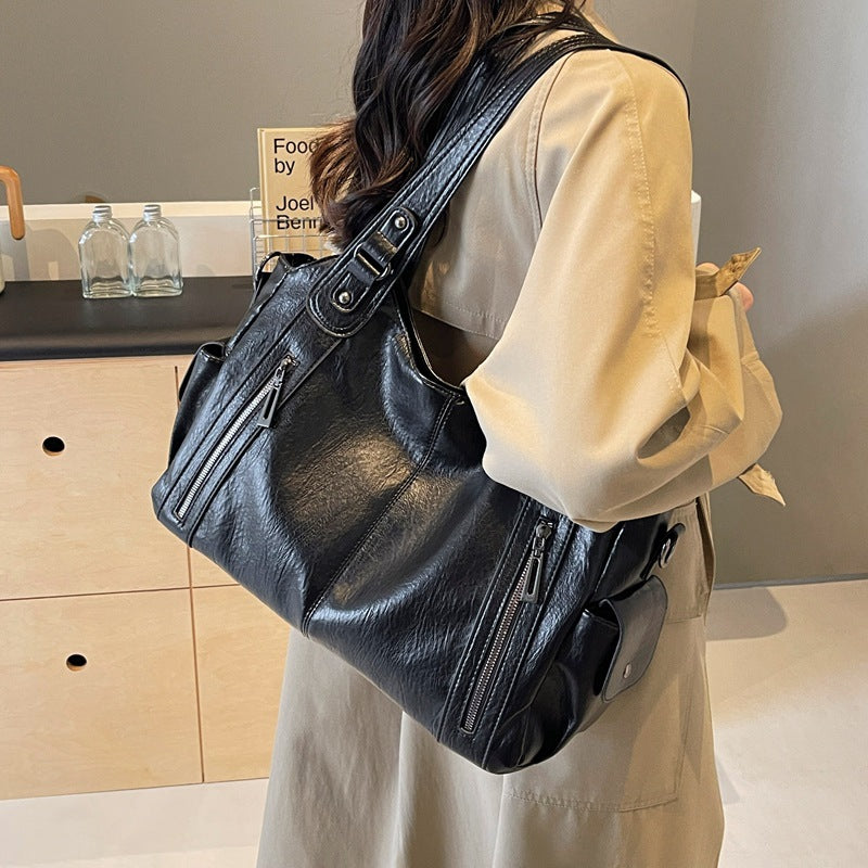 Women’s retro PU handbag with top handles and shoulder strap, black, zip pockets.
