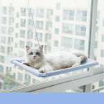 Cat window hammock perch with suction cups, light blue cushion, white cat lying down