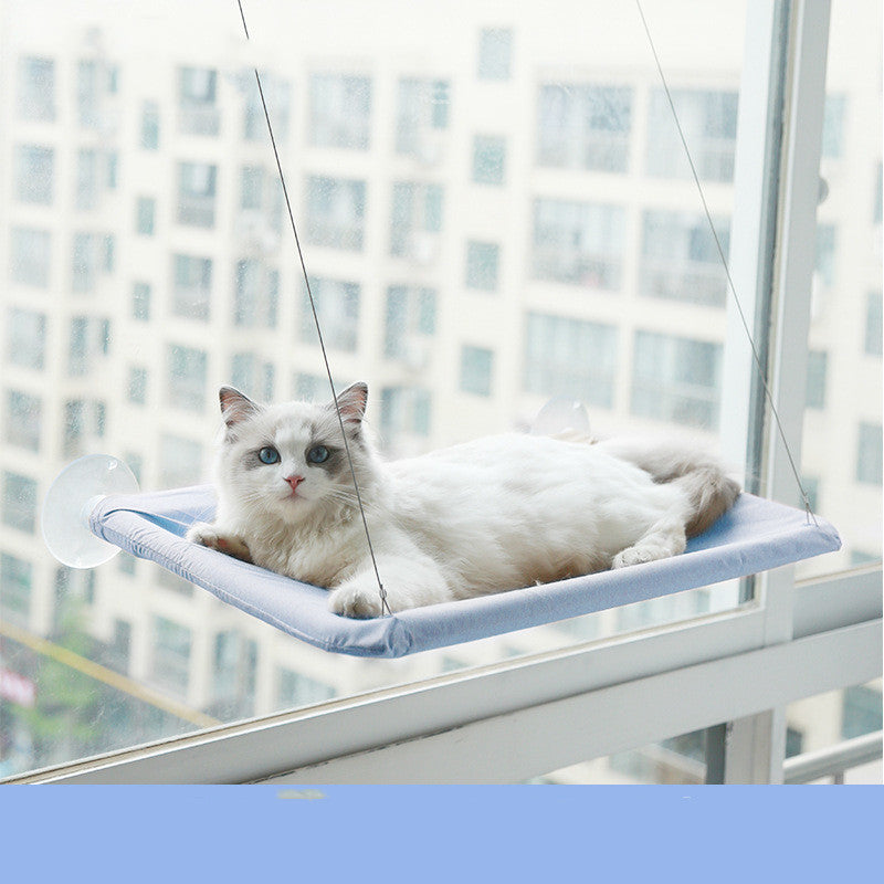 Cat window hammock perch with suction cups, light blue cushion, white cat lying down