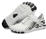 White water shoes with black graphic detailing, lace-up mesh upper, and tread sole.