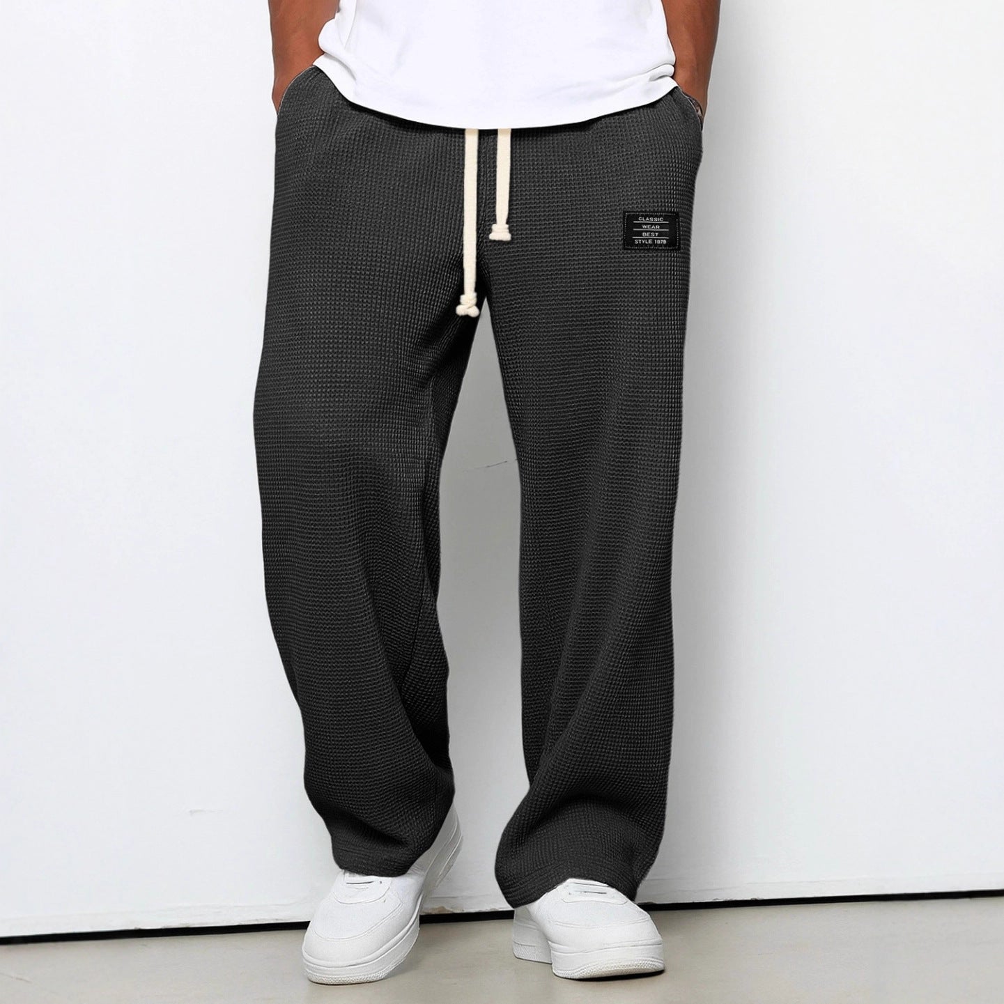 Waffle loose drawstring trousers in black with mid-to-high waistband and straight legs