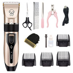 Beige pet hair clipper with multiple comb guards, scissors, brush, and charging cable.
