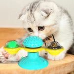 Cat rotating windmill toy with turquoise spiky top and three yellow rotating discs