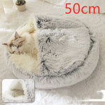 Light grey round plush pet bed with shag hood, cat resting and sleeping.