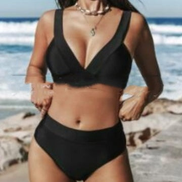 Black V-neck triangle bikini top and matching high-rise bikini bottoms on a beach.