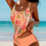 High-waist bikini swimsuit with coral-orange patterned tank top and peach solid bottoms