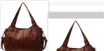 Brown PU handbag with top handles, shoulder strap, and front zip pockets