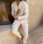 White long-sleeve lapel shirt and slim trousers set, standing pose with button front.