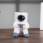 Astronaut resin phone stand front view with black helmet and white suit
