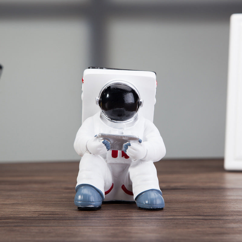 Astronaut resin phone stand front view with black helmet and white suit