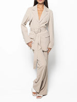 Beige belted blazer and high-waist pants set, blazer with flap pockets, belted waist, wide-leg pants.