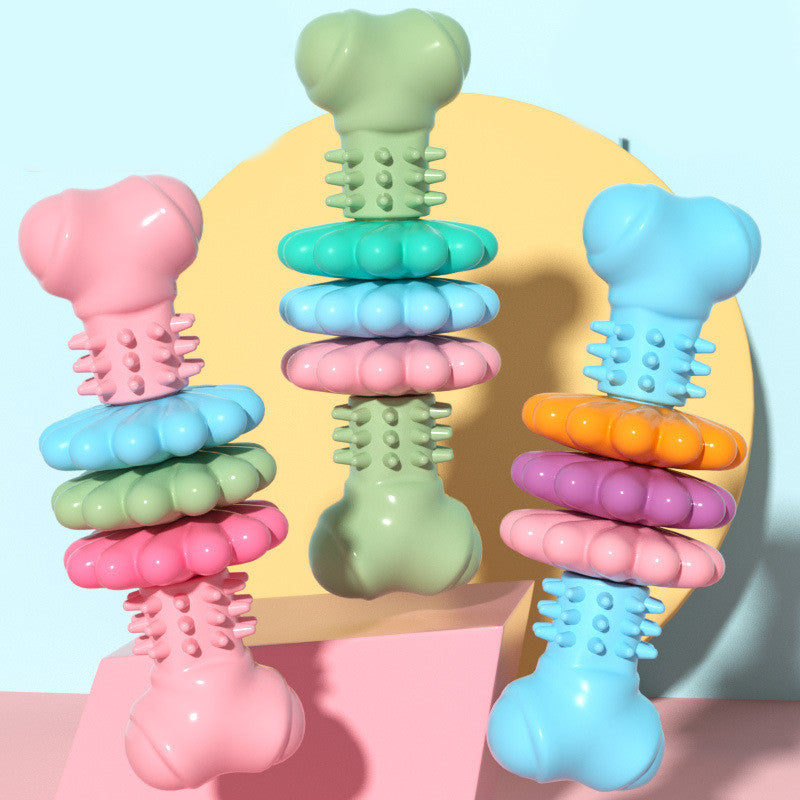 Stacked dog bone chew toys with textured nubs in pink, blue, and green