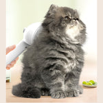 White pet grooming brush brushing a gray cat’s fluffy coat, handheld comb head