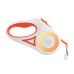 Orange retractable pet leash with glowing LED ring and metal snap hook
